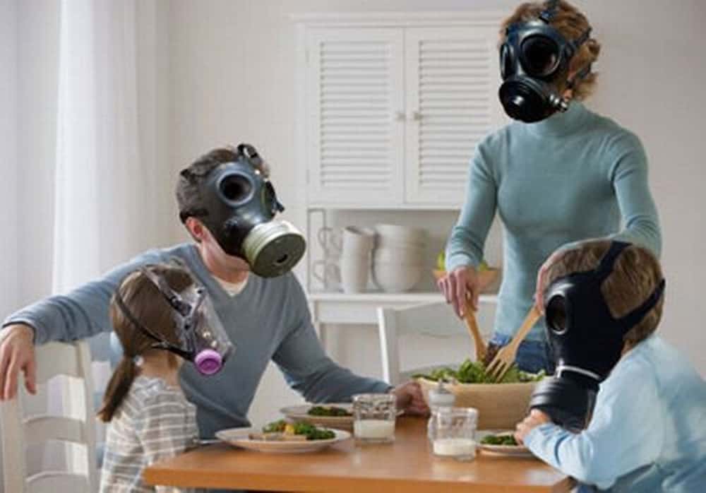 family gas wearing gas masks at home